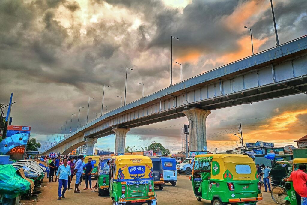 a group of vehicles parked next to each other under a bridge